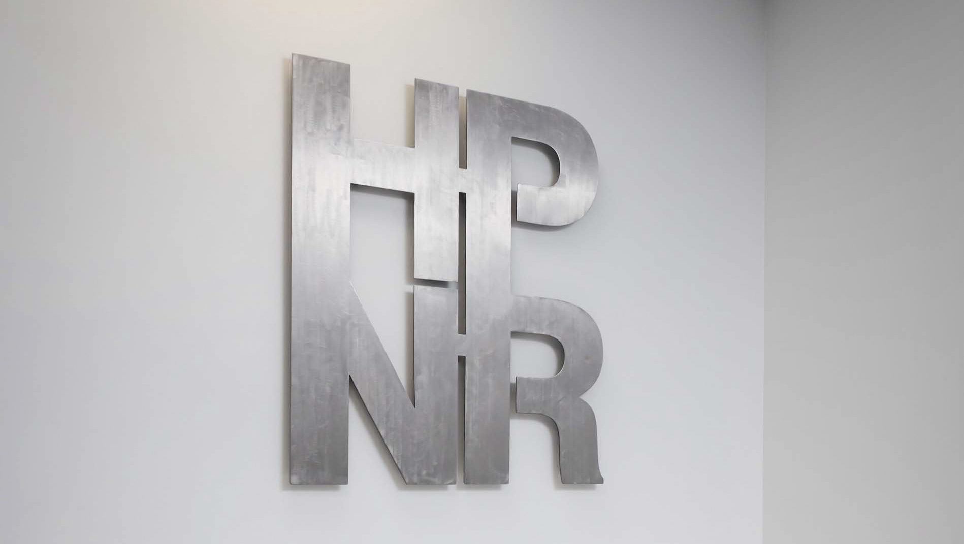 Halle Porter Newland & Rickett logo signage on wall